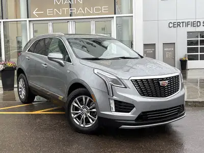 The 2023 Cadillac XT5, finished in a sleek Argent Silver Metallic paint, offers a confident all-whee...