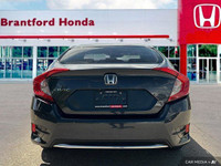 This 2019 Honda Civic Sedan EX boasts a stunning Cosmic Blue Metallic exterior and a sleek black fab... (image 4)