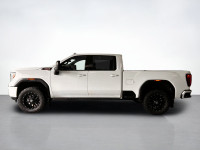 Drive our used Diesel powered 2021 GMC Sierra 2500 AT4 Crew Cab standard box 4X4 in Summit White and... (image 1)