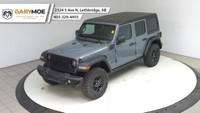 The 2025 Jeep Wrangler 4xe 4-Door Willys, in a striking gray, is a new adventure-ready 4x4 SUV that... (image 8)