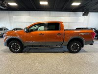 Take on your day in style with our 2019 Nissan Titan PRO-4X Crew Cab 4X4 shown off in Habanero Orang... (image 1)