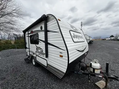 . 2016 Jayco 145RB Interior Features - Front convertible dinette that transforms into a queen-sized...