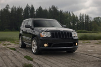 Equipped with a 420 hp 6.1L HEMI V8, AWD, Brembo brakes, and sport-tuned suspension for performance.... (image 1)
