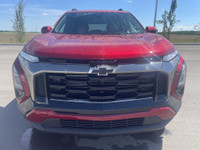 The 2025 Chevrolet Equinox ACTIV, dressed in a bold Radiant Red exterior with a distinctive Maple Su... (image 1)