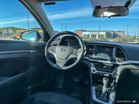 The 2017 Hyundai Elantra in Space Black Pearl features heated front seats, a heated leather steering... (image 9)