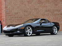 This isn’t just a car—it’s a statement. Draped in sleek black-on-black with polished chrome wheels t... (image 3)