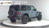 The 2025 Jeep Wrangler 4xe 4-Door Willys, in a striking gray, is a new adventure-ready 4x4 SUV that... (image 4)