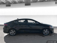 The 2017 Hyundai Elantra in Space Black Pearl features heated front seats, a heated leather steering... (image 6)