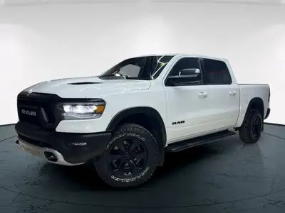 The 2022 Ram 1500 Rebel 4x4 Crew Cab 57 Box in stunning white lets you command every road with confi...