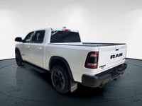 The 2022 Ram 1500 Rebel 4x4 Crew Cab 57 Box in stunning white lets you command every road with confi... (image 5)