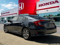 This 2019 Honda Civic Sedan EX boasts a stunning Cosmic Blue Metallic exterior and a sleek black fab... (image 3)