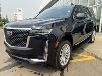 The 2021 Cadillac Escalade Luxury in Dark Moon Blue Metallic makes a bold statement with its 22-inch... (image 3)