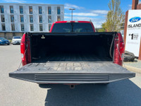 This 2015 Ford F-150 XLT has a Ruby Red Metallic exterior and Black Sport Interior with seating for... (image 6)