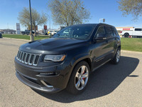 The 2014 Jeep Grand Cherokee SRT8 is a high-performance SUV that blends raw muscle, refined luxury,... (image 1)