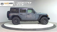 The 2025 Jeep Wrangler 4xe 4-Door Willys, in a striking gray, is a new adventure-ready 4x4 SUV that... (image 5)