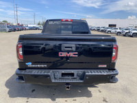 Poised for performance and utility, the 2018 GMC Sierra 1500 SLT stands proudly with a sleek Onyx Bl... (image 6)