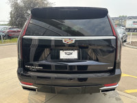 The 2021 Cadillac Escalade Luxury in Dark Moon Blue Metallic makes a bold statement with its 22-inch... (image 6)