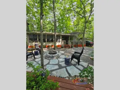 Stunning 2018 Kropf Park Model for sale, with picturesque landscaping! Modern interior, with open co...
