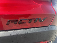 The 2025 Chevrolet Equinox ACTIV, dressed in a bold Radiant Red exterior with a distinctive Maple Su... (image 6)