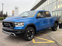 The 2022 Ram 1500 Rebel in Hydro Blue Pearl stands out with bold styling and off-road capability. Eq... (image 3)