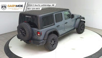 The 2025 Jeep Wrangler 4xe 4-Door Willys, in a striking gray, is a new adventure-ready 4x4 SUV that... (image 9)