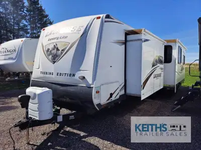 The 311RLS LaCrosse travel trailer by Prime Time Manufacturing offers two entrances, either in the r...