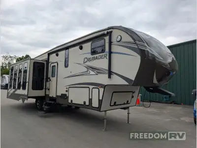 The Crusader 322RES fifth wheel by Prime Time Manufacturing offers triple slides and a rear entertai...