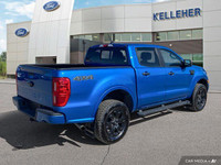 This 2021 Ford Ranger 4x4 Crew Cab, Velocity Blue with a sleek black interior, is ready for adventur... (image 4)