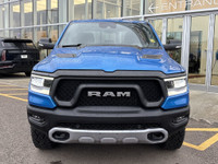 The 2022 Ram 1500 Rebel in Hydro Blue Pearl stands out with bold styling and off-road capability. Eq... (image 1)