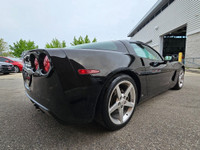 This isn’t just a car—it’s a statement. Draped in sleek black-on-black with polished chrome wheels t... (image 7)