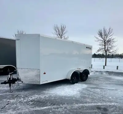 6x14 dual axle cargo trailer. 72 inch interior wall height. Ramp door. Comes with spare tire. White...