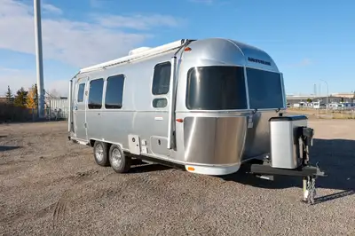 The 2025 Airstream International 23FBQ in Aqua exterior with a Coastal Cove interior is designed for...