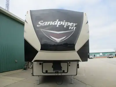 Enjoy this 3 slide fifth wheel which has a front queen bedroom , side bath w/ skylight over the show...