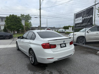 This 2014 BMW 320 is a sleek and reliable sedan that's sure to turn heads. With its stylish white ex... (image 1)