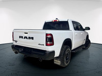 The 2022 Ram 1500 Rebel 4x4 Crew Cab 57 Box in stunning white lets you command every road with confi... (image 4)