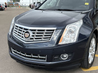 The 2015 Cadillac SRX Premium Collection, shown in Sapphire Blue Metallic, delivers confident perfor... (image 2)