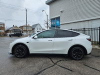 This stunning TESLA MODEL Y WITH UPGRADED LUXURIOUS Pearl White Exterior paint option with the stunn... (image 2)