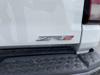 The 2025 Chevrolet Colorado ZR2, presented in Summit White with a Jet Black/Artemis interior, is eng... (image 6)