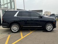 The 2021 Cadillac Escalade Luxury in Dark Moon Blue Metallic makes a bold statement with its 22-inch... (image 8)