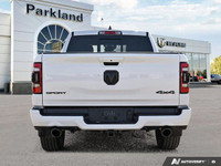 This 2023 Ram 1500 Sport Crew Cab 4x4 boasts a commanding presence with its Bright White exterior an... (image 4)