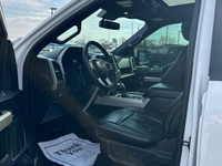 The Ford F-150 Lariat, dressed in a sleek white exterior and equipped with a 4x4 drivetrain, offers... (image 6)