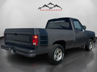 Step into the muscular allure of the 1991 Dodge D150 & W150 BASE, dressed in a commanding black hue.... (image 4)