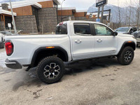 The 2024 GMC Canyon AT4X in Summit White is a rugged and capable mid-size off-road truck. Its bold e... (image 9)