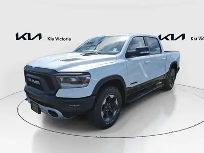 The 2019 Ram 1500 Rebel 4x4 Crew Cab, in a striking white finish with a capable 4x4 drivetrain, prom...
