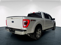 The 2021 Ford F-150 Lariat, clad in a stunning white coat and equipped with a robust 4x4 drivetrain,... (image 5)