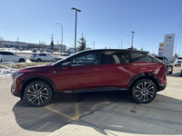 Finished in a head-turning Radiant Red Tricoat with a sleek Noir interior, the 2025 Cadillac Optiq E... (image 4)