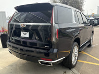 The 2021 Cadillac Escalade Luxury in Dark Moon Blue Metallic makes a bold statement with its 22-inch... (image 7)