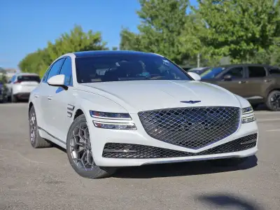 Experience the impressive 2023 Genesis G80 2.5T Advanced, a stunning white all-wheel-drive sedan tha...