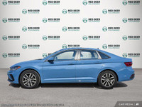 The 2025 Volkswagen Jetta Comfortline is a stunning blue sedan that offers a smooth driving experien... (image 2)