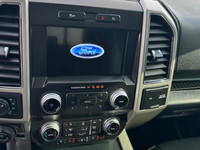 The Ford F-150 Lariat, dressed in a sleek white exterior and equipped with a 4x4 drivetrain, offers... (image 7)